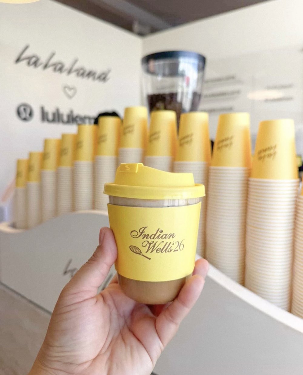 Custom-branded coffee cups for a brand activation — 58 Hester Custom-branded yellow coffee cups at a Los Angeles brand activation